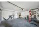 This well-equipped garage includes fitness machines, providing a home gym for convenient workouts at 13625 W Peck Ct, Litchfield Park, AZ 85340