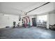 This organized garage includes a variety of exercise equipment, offering a convenient fitness space at home at 13625 W Peck Ct, Litchfield Park, AZ 85340