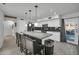 Well-lit kitchen with an island, granite countertops, and white cabinetry, perfect for cooking and entertaining at 13625 W Peck Ct, Litchfield Park, AZ 85340
