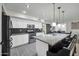 Open kitchen with granite countertops, stainless steel appliances, and an island with seating at 13625 W Peck Ct, Litchfield Park, AZ 85340