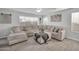 Comfortable living room with plush sectional sofa and decorative pillows, bathed in natural light at 13625 W Peck Ct, Litchfield Park, AZ 85340