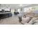 Bright open-concept living room with modern decor, including large sectional sofa and kitchen view at 13625 W Peck Ct, Litchfield Park, AZ 85340