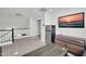 Loft area with mounted television, mini fridge, and hardwood flooring at 13625 W Peck Ct, Litchfield Park, AZ 85340