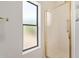 Bathroom with glass enclosed shower and a window bringing in natural light at 13805 N Hamilton Dr # H102, Fountain Hills, AZ 85268