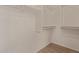 Walk-in closet with wood look flooring and built-in shelving and rails at 13805 N Hamilton Dr # H102, Fountain Hills, AZ 85268