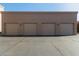 Four car garage with beige doors and exterior lighting at 13805 N Hamilton Dr # H102, Fountain Hills, AZ 85268