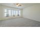 Comfortable bedroom with bright bay windows, neutral carpet, and simple decor at 14110 W White Rock Dr, Sun City West, AZ 85375