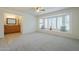Comfortable bedroom with bright bay windows, neutral carpet, and simple decor at 14110 W White Rock Dr, Sun City West, AZ 85375