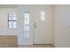 Front door with a decorative glass insert and nearby window with shutters at 14110 W White Rock Dr, Sun City West, AZ 85375
