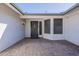 View of the tiled front entrance patio with the front door and security screen at 14110 W White Rock Dr, Sun City West, AZ 85375