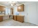 Practical home office with wooden cabinetry, built-in desk, and tile floors at 14110 W White Rock Dr, Sun City West, AZ 85375