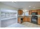 Kitchen with a view into the bright sunroom with large windows at 14110 W White Rock Dr, Sun City West, AZ 85375