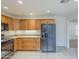 Well-lit kitchen with wooden cabinets and black appliances at 14110 W White Rock Dr, Sun City West, AZ 85375