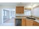 Cozy kitchen features wooden cabinetry, tile floors, and stainless steel appliances at 14110 W White Rock Dr, Sun City West, AZ 85375