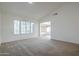 Bright living room with neutral carpet, vaulted ceilings, and lots of natural light at 14110 W White Rock Dr, Sun City West, AZ 85375