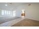 Spacious open-concept living room leads to the kitchen with plenty of natural light at 14110 W White Rock Dr, Sun City West, AZ 85375