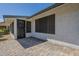 Paved outdoor patio area with a secure screen door and access to yard at 14110 W White Rock Dr, Sun City West, AZ 85375