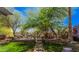 Scenic backyard featuring a stone patio, beautiful landscaping, mature shade trees, and a charming garden at 1421 W Saltsage Dr, Phoenix, AZ 85045