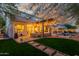 Expansive backyard with a covered patio, lounge seating, and lush greenery, ideal for relaxation and enjoyment at 1421 W Saltsage Dr, Phoenix, AZ 85045