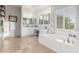 Bright bathroom with white cabinets, shiplap walls, soaking tub and double vanity at 1421 W Saltsage Dr, Phoenix, AZ 85045