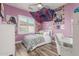 Vibrant bedroom with a window view, playful decor, and practical study area at 1421 W Saltsage Dr, Phoenix, AZ 85045
