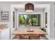 Charming breakfast nook with views of the backyard pool through a large window at 1421 W Saltsage Dr, Phoenix, AZ 85045