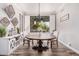 Inviting dining room featuring a rustic wooden table and ample natural light from the large window at 1421 W Saltsage Dr, Phoenix, AZ 85045