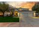 Charming home with a lush green lawn and three-car garage, perfect for Gathering living at 1421 W Saltsage Dr, Phoenix, AZ 85045