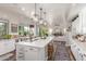 Bright, open kitchen featuring a spacious island, modern lighting, and seamless flow to the living area at 1421 W Saltsage Dr, Phoenix, AZ 85045