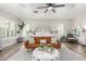 Bright main bedroom with a decorative headboard and ceiling fan over a sitting area with a leather couch at 1421 W Saltsage Dr, Phoenix, AZ 85045