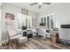 Bright home office with wood floors, white plantation shutters, and a modern, height-adjustable desk at 1421 W Saltsage Dr, Phoenix, AZ 85045