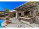 Backyard covered patio includes outdoor kitchen with a bar and shaded dining space near a pristine pool at 1421 W Saltsage Dr, Phoenix, AZ 85045