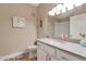 Bright bathroom featuring a white vanity, framed mirror, decorative wall art, and tiled shower area at 15050 N Thompson Peak Pkwy # 2072, Scottsdale, AZ 85260