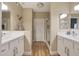 Elegant bathroom with dual sinks, white cabinets, and walk-in shower at 15050 N Thompson Peak Pkwy # 2072, Scottsdale, AZ 85260