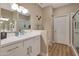 Modern bathroom with a well-lit vanity, walk-in shower, and wood style floors at 15050 N Thompson Peak Pkwy # 2072, Scottsdale, AZ 85260