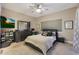 Spacious bedroom with a ceiling fan, dresser, and large bed at 15050 N Thompson Peak Pkwy # 2072, Scottsdale, AZ 85260
