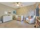 Cozy Bedroom featuring a crib, dresser, floral wallpaper, area rug, and comfortable rocking chair with throw pillows at 15050 N Thompson Peak Pkwy # 2072, Scottsdale, AZ 85260