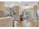 Open dining area with modern chandelier, light wood floors and large windows with natural light at 15050 N Thompson Peak Pkwy # 2072, Scottsdale, AZ 85260