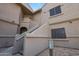 Condominium building with light brown stucco and painted house number 2072 and several windows with screens at 15050 N Thompson Peak Pkwy # 2072, Scottsdale, AZ 85260