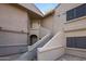 Exterior view of a multi-unit residential building showcasing staircases leading to the upper level units at 15050 N Thompson Peak Pkwy # 2072, Scottsdale, AZ 85260