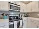 Kitchen featuring modern appliances, microwave, oven, white countertops, and tiled backsplash at 15050 N Thompson Peak Pkwy # 2072, Scottsdale, AZ 85260