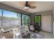 Bright sunroom with large windows showcasing neighborhood views, ceiling fan, and a play area perfect for  at 15050 N Thompson Peak Pkwy # 2072, Scottsdale, AZ 85260