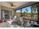 Enclosed sunroom features large windows with views, a ceiling fan, neutral flooring, and ' play area at 15050 N Thompson Peak Pkwy # 2072, Scottsdale, AZ 85260