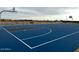 Community basketball court with blue and gray surface, perfect for neighborhood games at 15781 W Beryl Ave, Waddell, AZ 85355