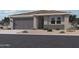 Charming single-story home with a two-car garage and low-maintenance desert landscaping at 15781 W Beryl Ave, Waddell, AZ 85355