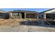 New home exterior showing stucco, roof tile installation, and an attached two-car garage at 15781 W Beryl Ave, Waddell, AZ 85355
