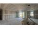 An airy living room featuring drywall, large windows, and sliding doors that open to the exterior at 15781 W Beryl Ave, Waddell, AZ 85355