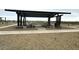 Covered picnic area with multiple tables and seating in the community park at 15781 W Beryl Ave, Waddell, AZ 85355