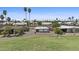 View of the home's backyard featuring desert landscaping and a covered patio area at 1707 S 72Nd St, Mesa, AZ 85209