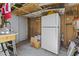 Unfinished shed with exposed beams and a white refrigerator at 1707 S 72Nd St, Mesa, AZ 85209